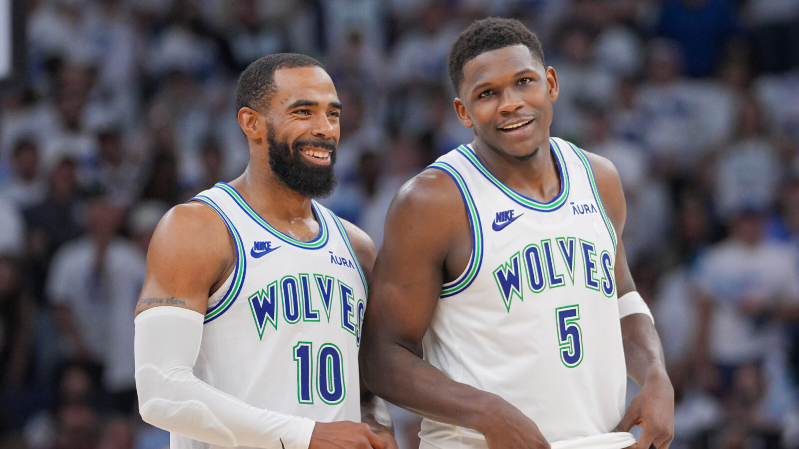 Minnesota Timberwolves guard Mike Conley (10) and guard Anthony Edwards (5) talk against the Denver Nuggets in the fourth quarter during game six of the second round for the 2024 NBA playoffs at Target Center.