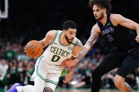 Jun 6, 2024; Boston, Massachusetts, USA; Boston Celtics forward Jayson Tatum (0) controls the ball against Dallas Mavericks center Dereck Lively II (2) in the third quarter during game one of the 2024 NBA Finals at TD Garden.