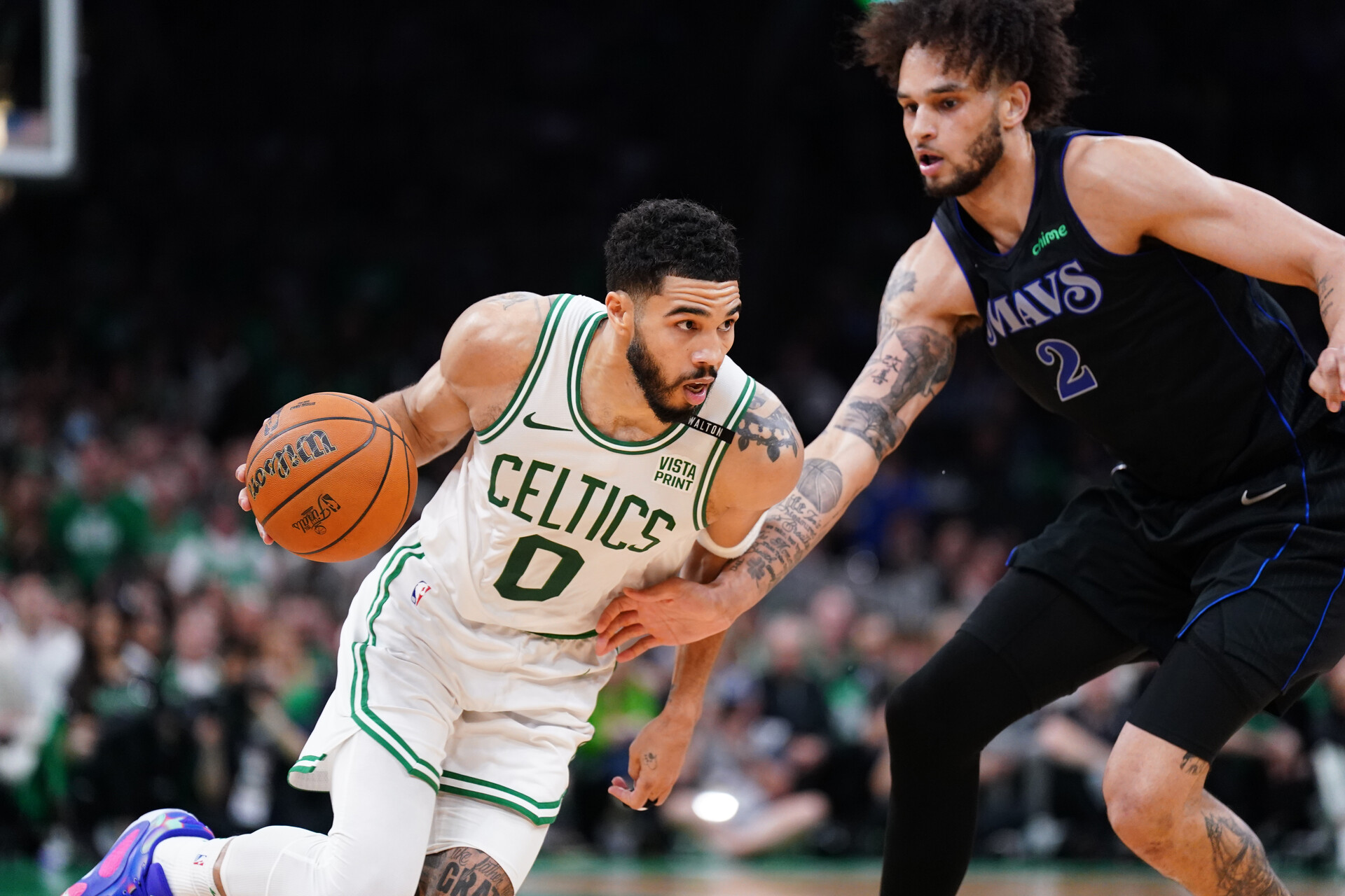 Jun 6, 2024; Boston, Massachusetts, USA; Boston Celtics forward Jayson Tatum (0) controls the ball against Dallas Mavericks center Dereck Lively II (2) in the third quarter during game one of the 2024 NBA Finals at TD Garden.