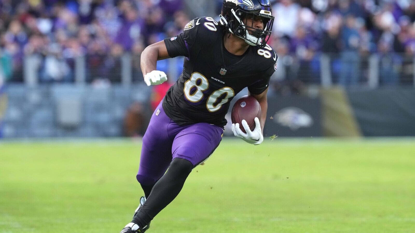 Dec 31, 2023; Baltimore, Maryland, USA; Baltimore Ravens tight end Isaiah Likely (80) runs following his catch for a second quarter touchdown against the Miami Dolphins at M&T Bank Stadium.