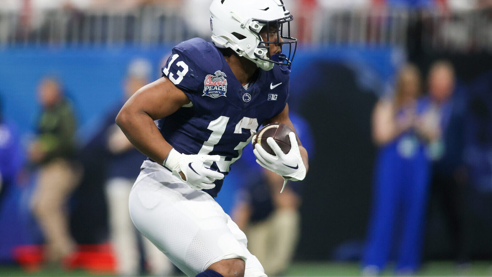 Dec 30, 2023; Atlanta, GA, USA; Penn State Nittany Lions running back Kaytron Allen (13) runs the ball against the Mississippi Rebels in the first quarter at Mercedes-Benz Stadium.