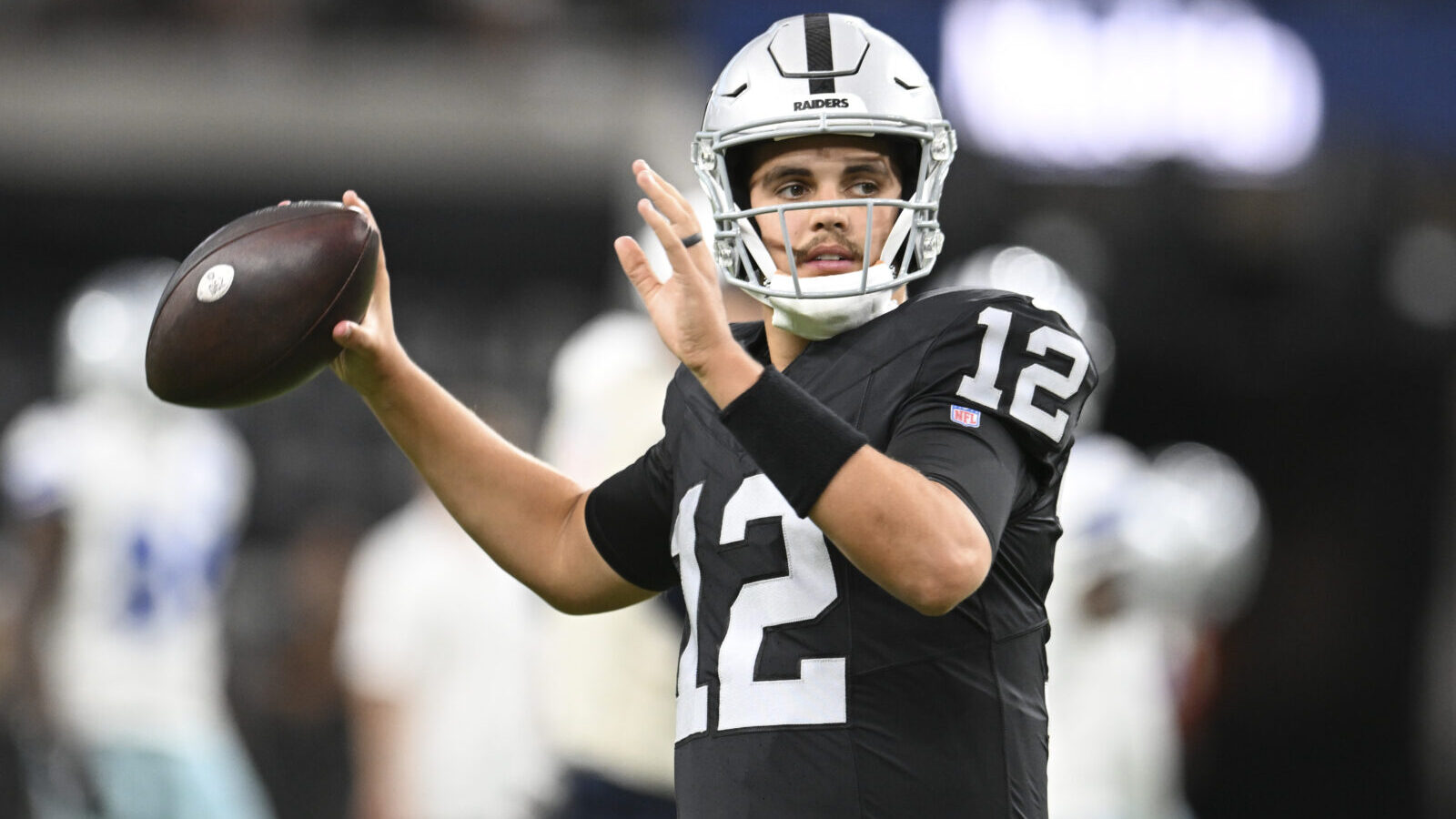 Aug 17, 2024; Paradise, Nevada, USA; Las Vegas Raiders quarterback Aidan O'Connell (12) warms up against the Dallas Cowboys at Allegiant Stadium.