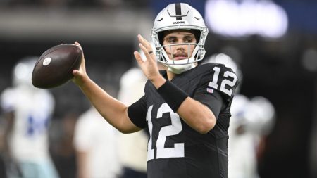 Aug 17, 2024; Paradise, Nevada, USA; Las Vegas Raiders quarterback Aidan O'Connell (12) warms up against the Dallas Cowboys at Allegiant Stadium.