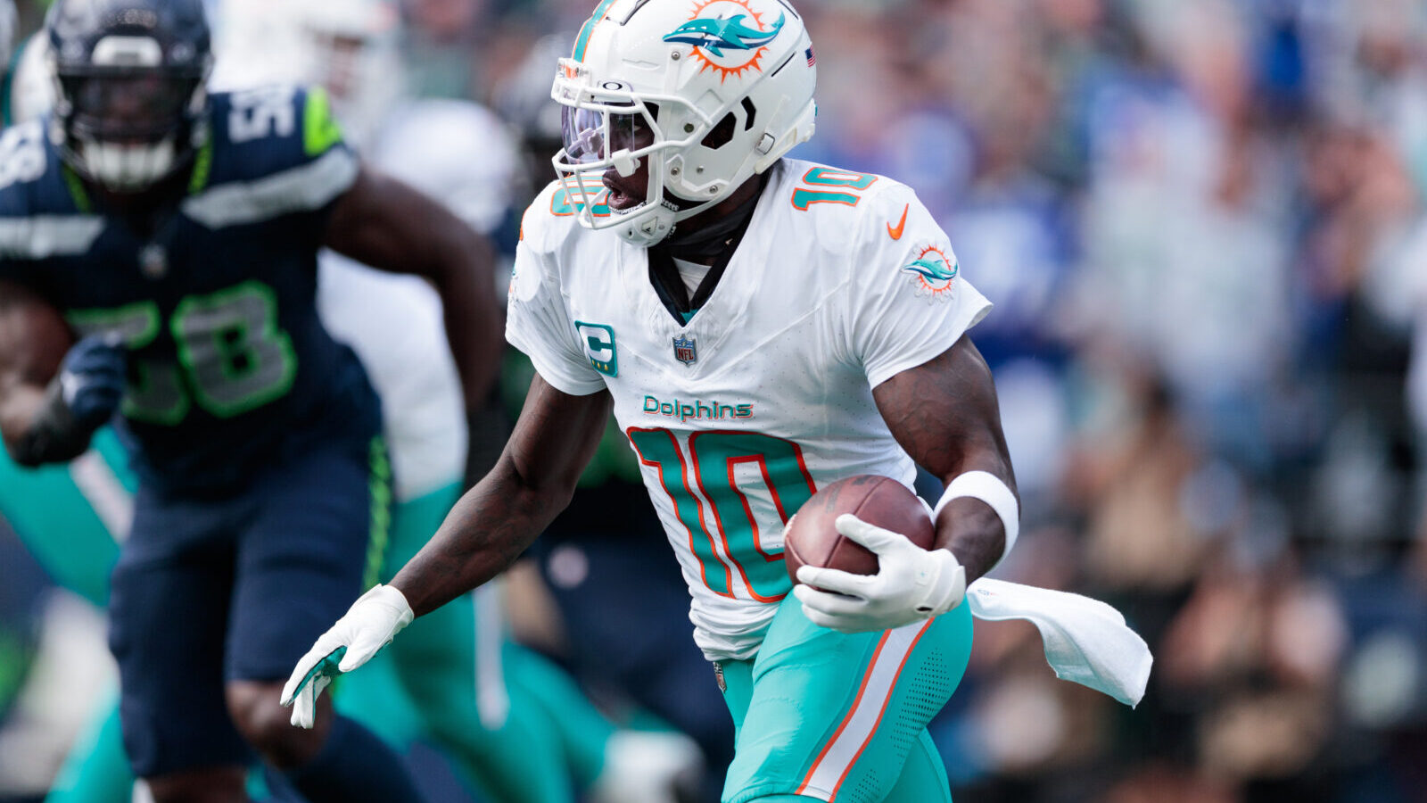 Sep 22, 2024; Seattle, Washington, USA; Miami Dolphins wide receiver Tyreek Hill (10) runs with the ball during the third quarter against Seattle Seahawks at Lumen Field.