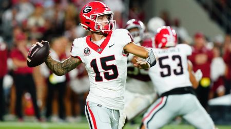 Sep 28, 2024; Tuscaloosa, Alabama, USA; Georgia Bulldogs quarterback Carson Beck (15) rolls out to throw against the Alabama Crimson Tide during the third quarter at Bryant-Denny Stadium.