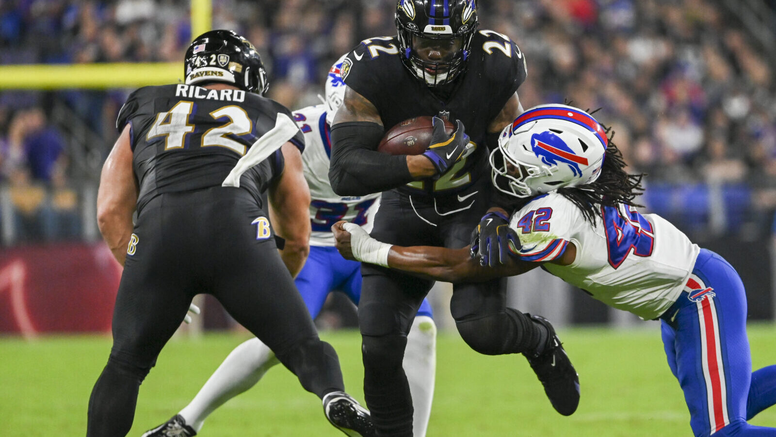 Sep 29, 2024; Baltimore, Maryland, USA; Baltimore Ravens running back Derrick Henry (22) runs through Buffalo Bills linebacker Dorian Williams (42) tackle attempt during the first half at M&T Bank Stadium.