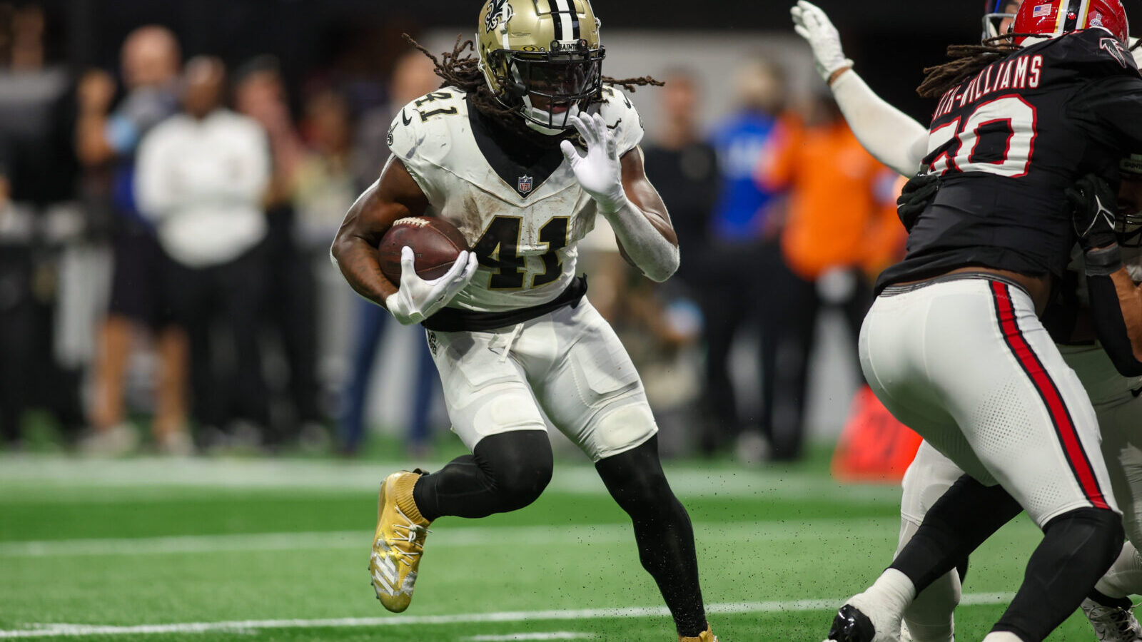 Sep 29, 2024; Atlanta, Georgia, USA; New Orleans Saints running back Alvin Kamara (41) runs the ball against the Atlanta Falcons in the fourth quarter at Mercedes-Benz Stadium.