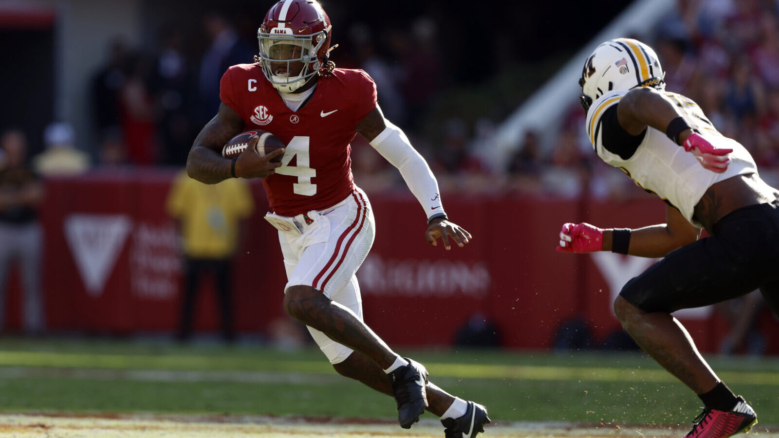 Oct 26, 2024; Tuscaloosa, Alabama, USA; Alabama Crimson Tide quarterback Jalen Milroe (4) scrambles around Missouri Tigers cornerback Toriano Pride Jr. (2) for a first down during the first half at Bryant-Denny Stadium.