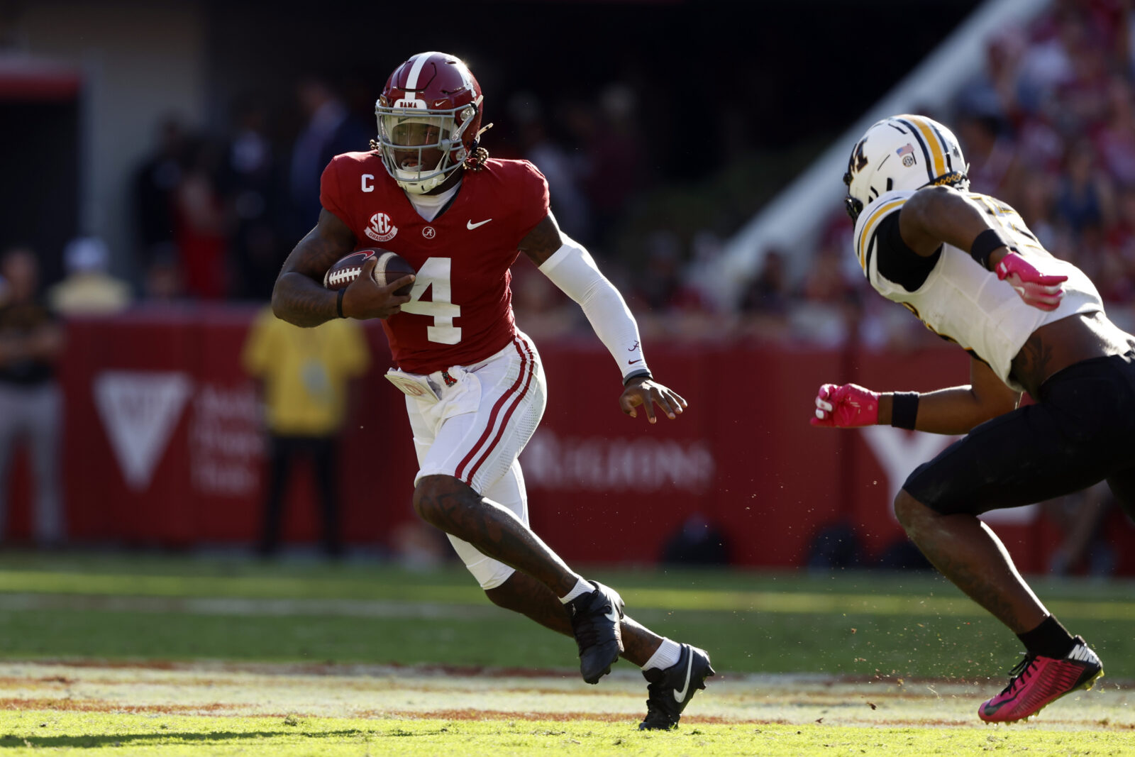 Oct 26, 2024; Tuscaloosa, Alabama, USA; Alabama Crimson Tide quarterback Jalen Milroe (4) scrambles around Missouri Tigers cornerback Toriano Pride Jr. (2) for a first down during the first half at Bryant-Denny Stadium.