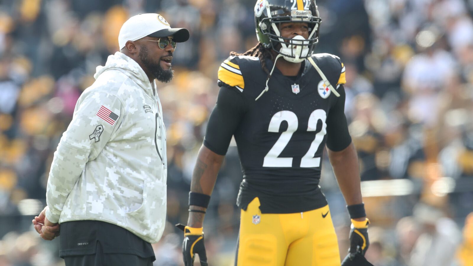 Nov 17, 2024; Pittsburgh, Pennsylvania, USA; Pittsburgh Steelers head coach Mike Tomlin (left) and running back Najee Harris (22) talk during warm ups before the game against the Baltimore Ravens at Acrisure Stadium.