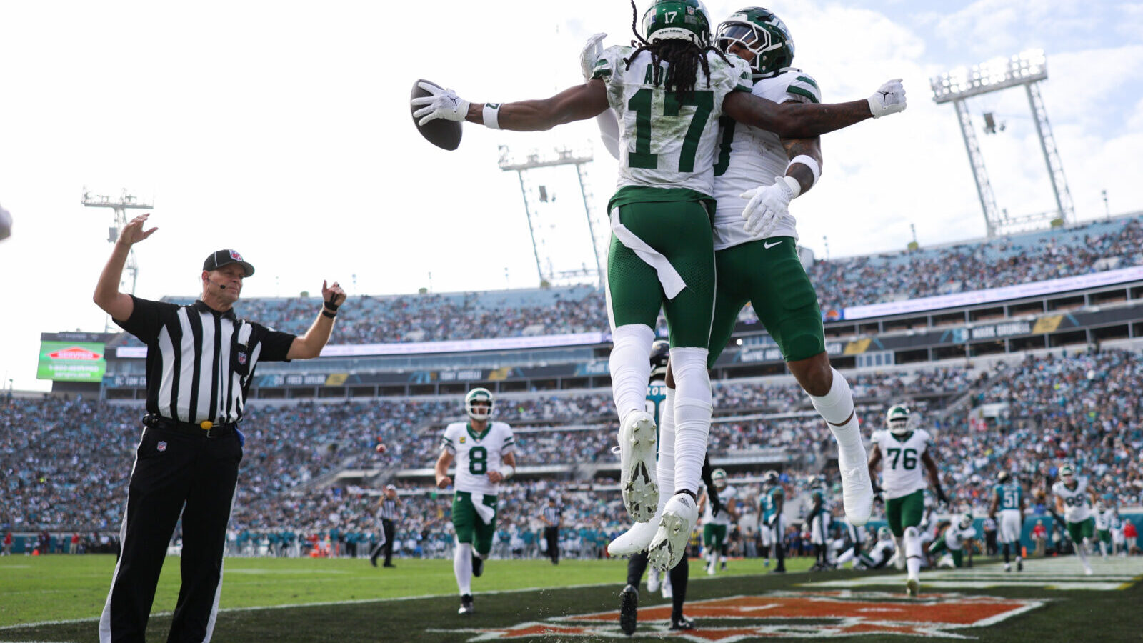 Dec 15, 2024; Jacksonville, Florida, USA; New York Jets wide receiver Davante Adams (17) celebrates with running back Braelon Allen (0) after scoring a touchdown against the Jacksonville Jaguars in the third quarter at EverBank Stadium.