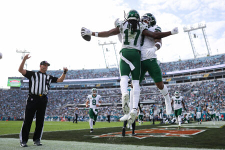 Dec 15, 2024; Jacksonville, Florida, USA; New York Jets wide receiver Davante Adams (17) celebrates with running back Braelon Allen (0) after scoring a touchdown against the Jacksonville Jaguars in the third quarter at EverBank Stadium.
