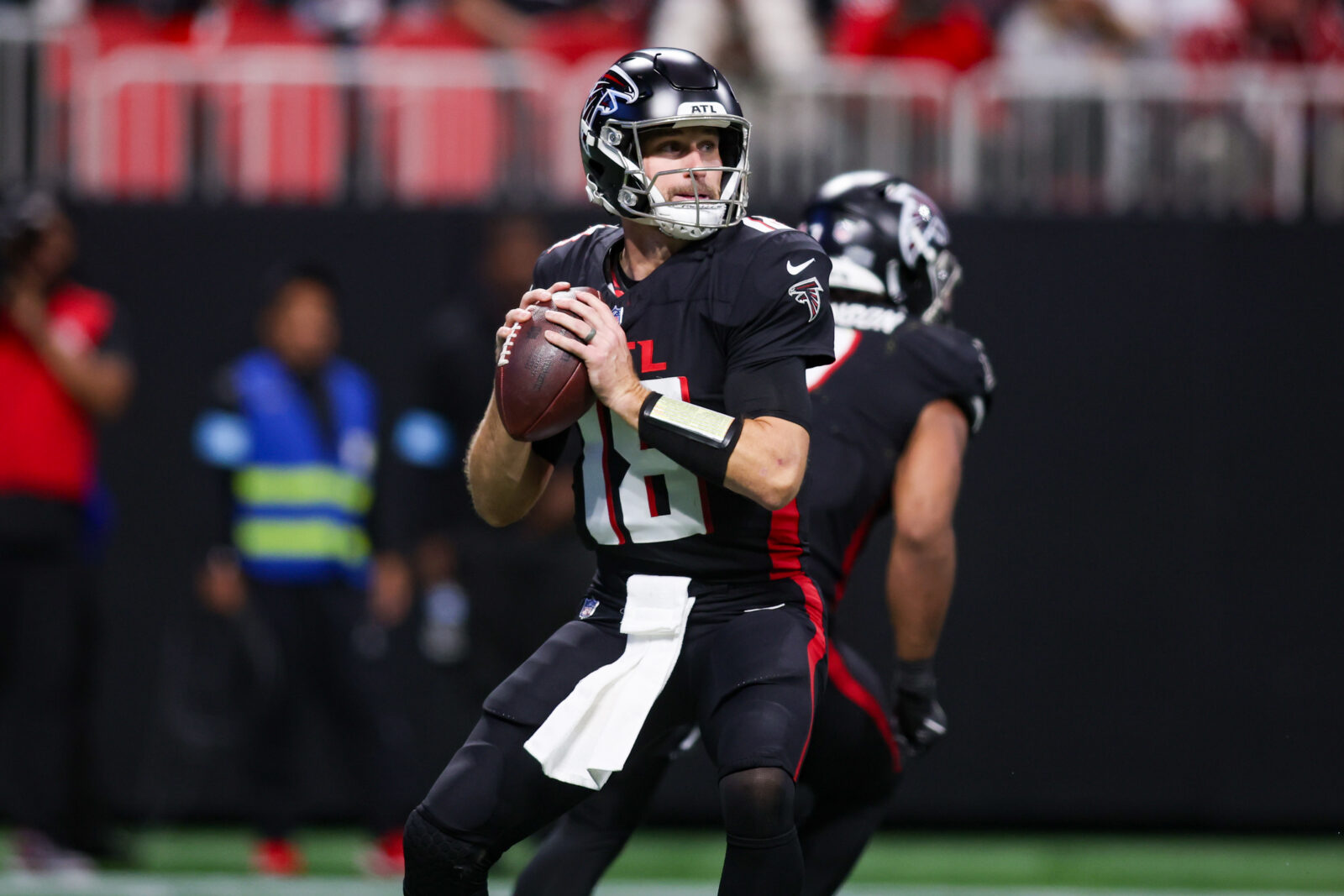 Dec 1, 2024; Atlanta, Georgia, USA; Atlanta Falcons quarterback Kirk Cousins (18) drops back to pass against the Los Angeles Chargers in the fourth quarter at Mercedes-Benz Stadium.