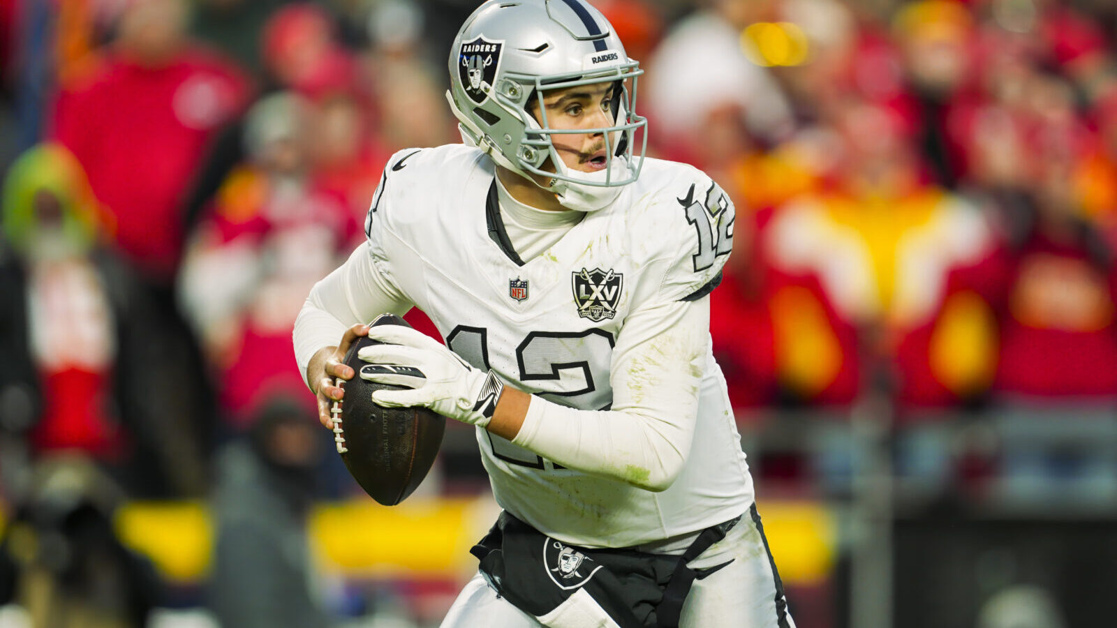 Nov 29, 2024; Kansas City, Missouri, USA; Las Vegas Raiders quarterback Aidan O'Connell (12) rolls out to pass during the second half against the Kansas City Chiefs at GEHA Field at Arrowhead Stadium.