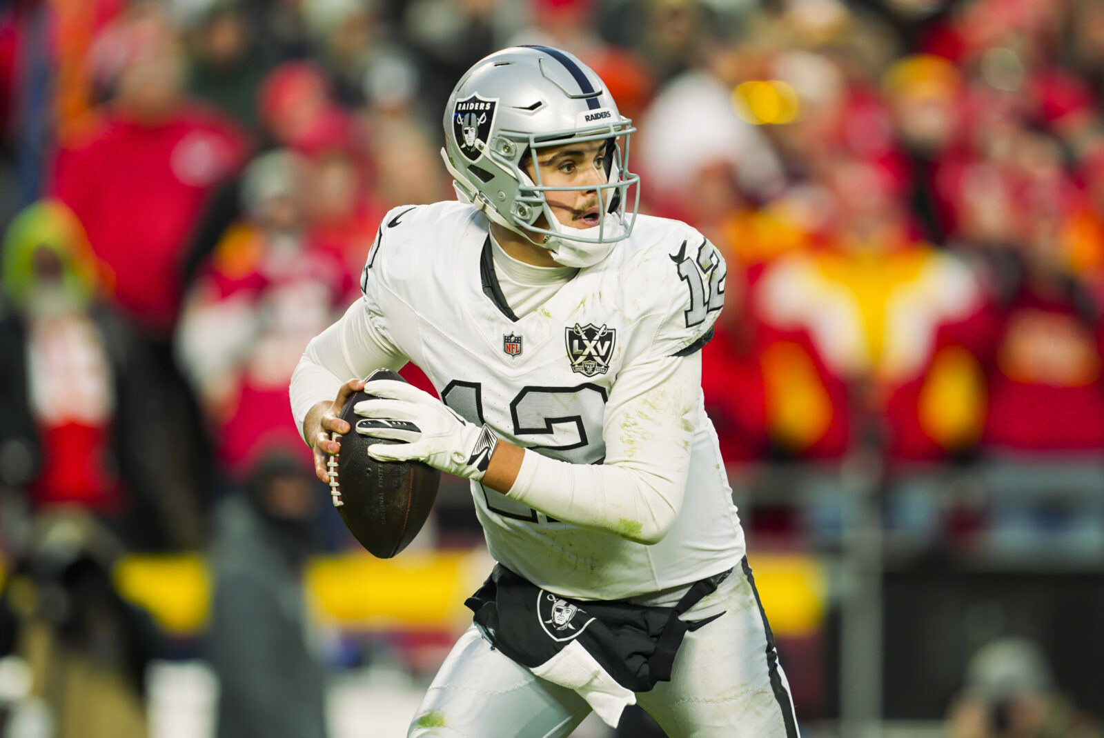 Nov 29, 2024; Kansas City, Missouri, USA; Las Vegas Raiders quarterback Aidan O'Connell (12) rolls out to pass during the second half against the Kansas City Chiefs at GEHA Field at Arrowhead Stadium.