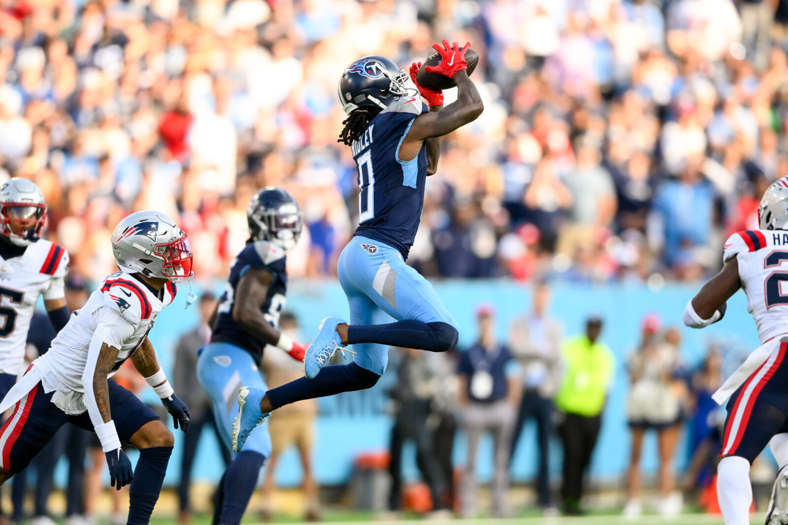 Nov 3, 2024; Nashville, Tennessee, USA; Tennessee Titans wide receiver Calvin Ridley (0) makes a catch between New England Patriots safety Jaylinn Hawkins (21) and New England Patriots cornerback Christian Gonzalez (0) during the second half at Nissan Stadium. Ridley is one of our favorite Underdog NFLSZN picks.