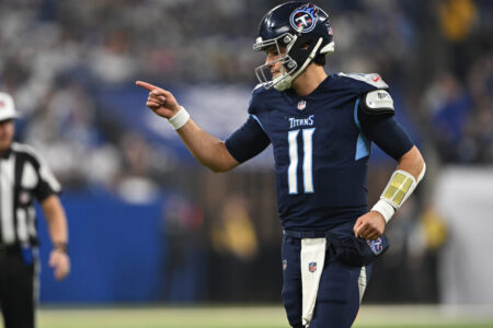 Dec 22, 2024; Indianapolis, Indiana, USA; Tennessee Titans quarterback Mason Rudolph (11) reacts to a touchdown during the first quarter against the Indianapolis Colts at Lucas Oil Stadium.
