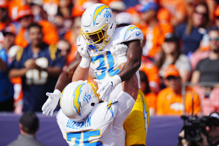 Oct 13, 2024; Denver, Colorado, USA; Los Angeles Chargers center Bradley Bozeman (75) celebrates running back Kimani Vidal (30) touchdown in the first quarter against the Denver Broncos at Empower Field at Mile High.
