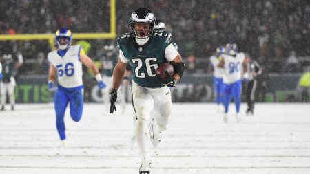 Jan 19, 2025; Philadelphia, Pennsylvania, USA; Philadelphia Eagles running back Saquon Barkley (26) carries the ball to score a touchdown against the Los Angeles Rams in the second half in a 2025 NFC divisional round game at Lincoln Financial Field.