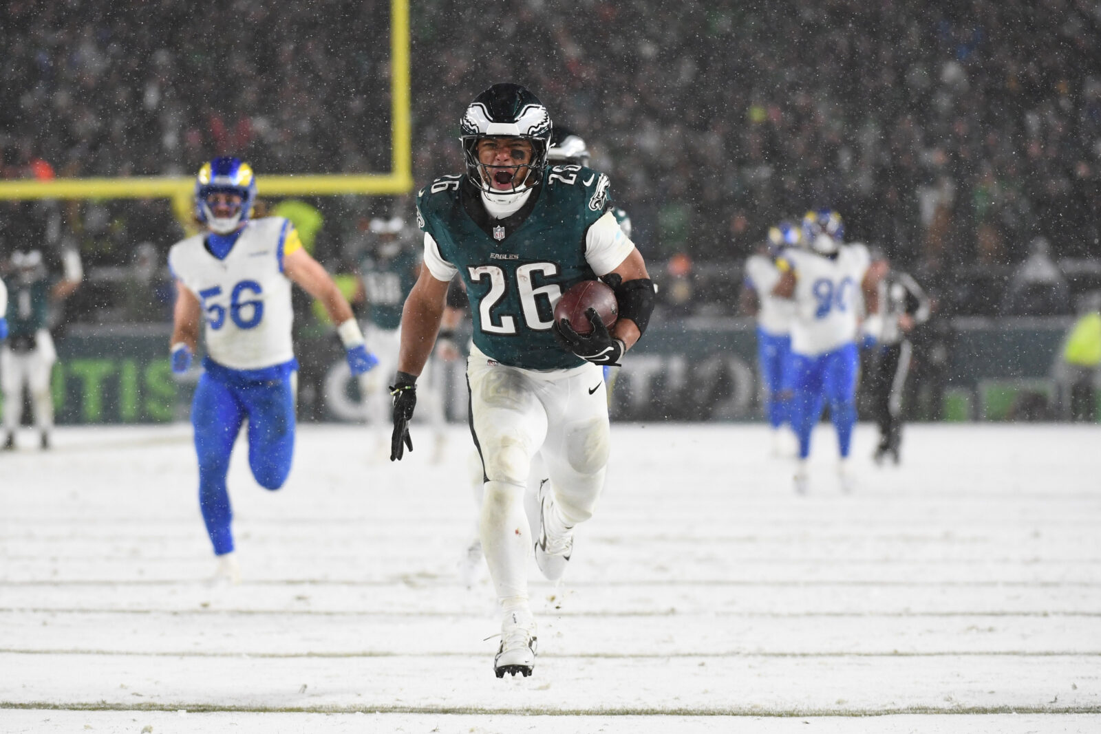Jan 19, 2025; Philadelphia, Pennsylvania, USA; Philadelphia Eagles running back Saquon Barkley (26) carries the ball to score a touchdown against the Los Angeles Rams in the second half in a 2025 NFC divisional round game at Lincoln Financial Field.