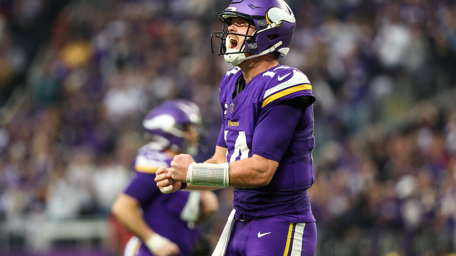 Dec 8, 2024; Minneapolis, Minnesota, USA; Minnesota Vikings quarterback Sam Darnold (14) celebrates his touchdown to wide receiver Jordan Addison (3) during the fourth quarter against the Atlanta Falcons at U.S. Bank Stadium.