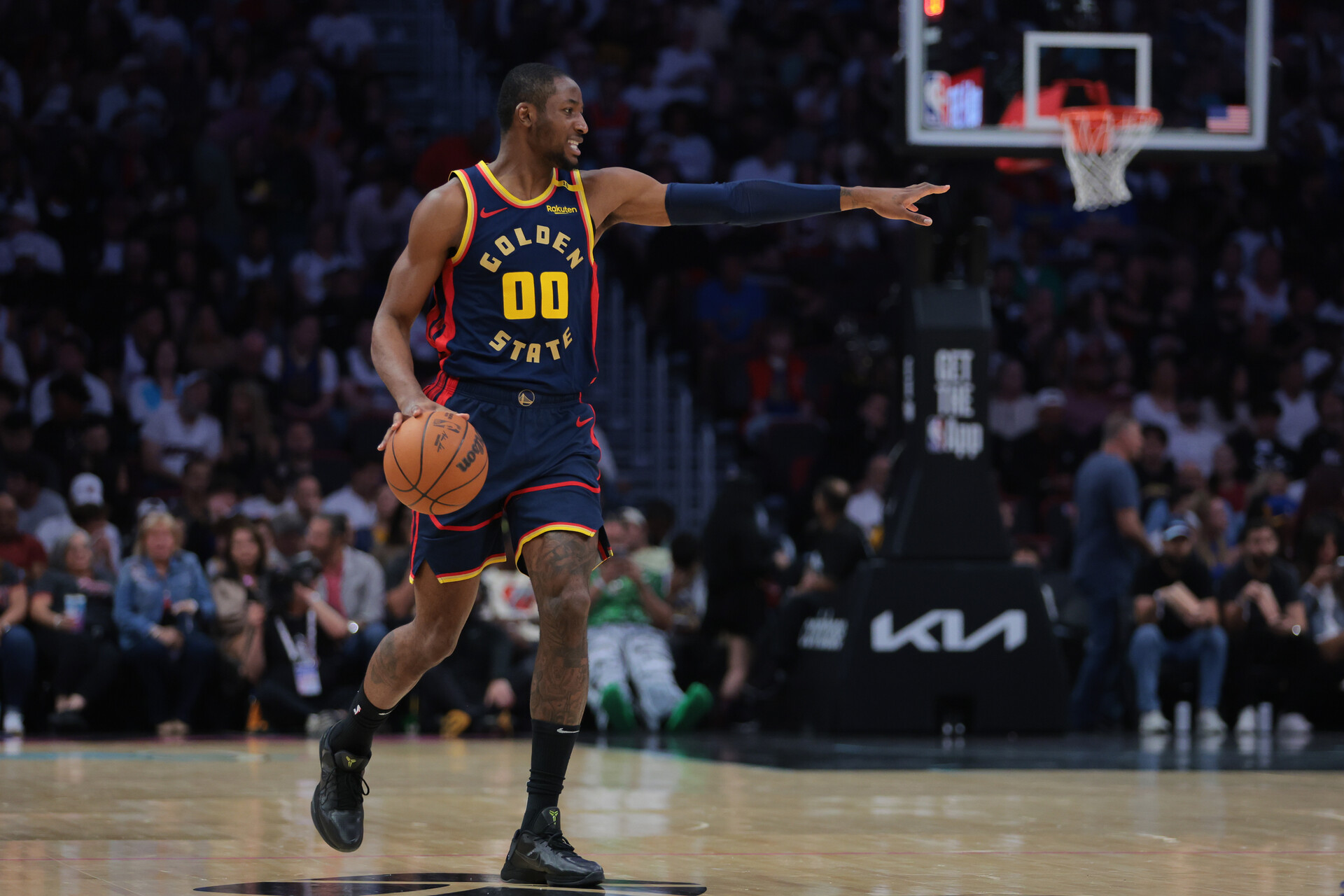 Mar 25, 2025; Miami, Florida, USA; Golden State Warriors forward Jonathan Kuminga (00) signals against the Miami Heat during the first quarter at Kaseya Center.