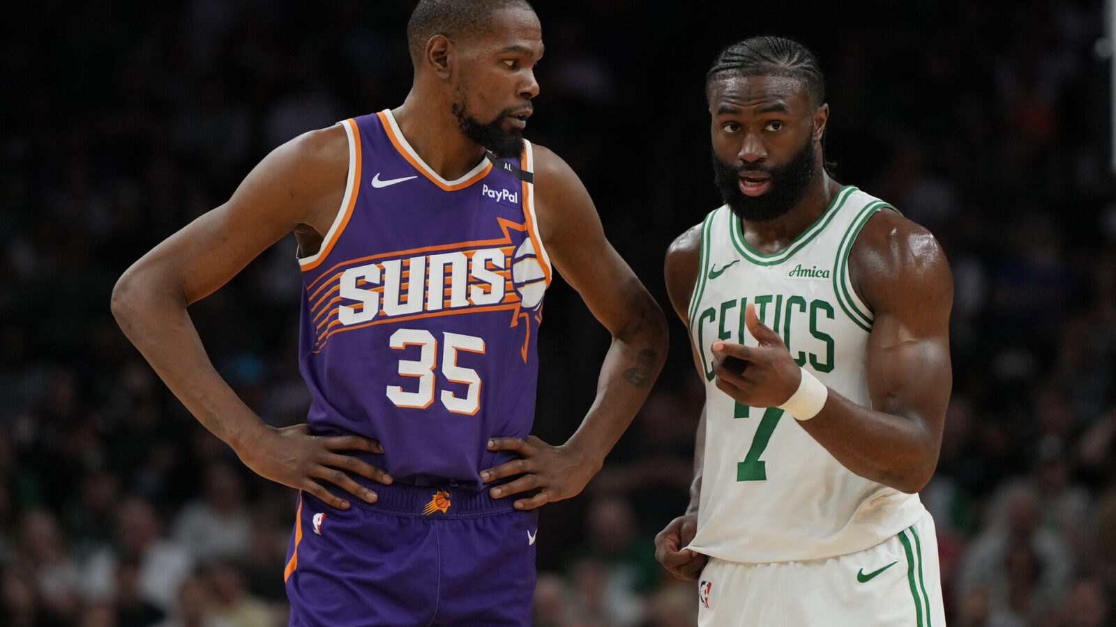 Mar 26, 2025; Phoenix, Arizona, USA; Phoenix Suns forward Kevin Durant (35) and Boston Celtics guard Jaylen Brown (7) talk during the second half at Footprint Center.