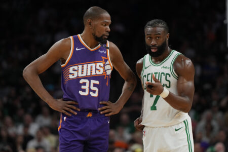 Mar 26, 2025; Phoenix, Arizona, USA; Phoenix Suns forward Kevin Durant (35) and Boston Celtics guard Jaylen Brown (7) talk during the second half at Footprint Center.