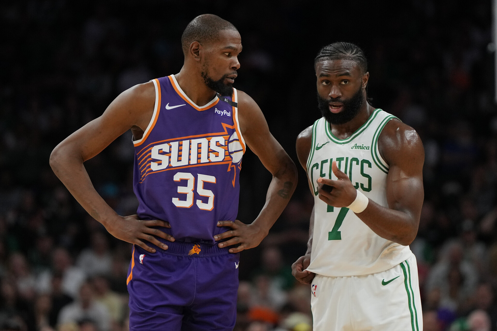 Mar 26, 2025; Phoenix, Arizona, USA; Phoenix Suns forward Kevin Durant (35) and Boston Celtics guard Jaylen Brown (7) talk during the second half at Footprint Center.