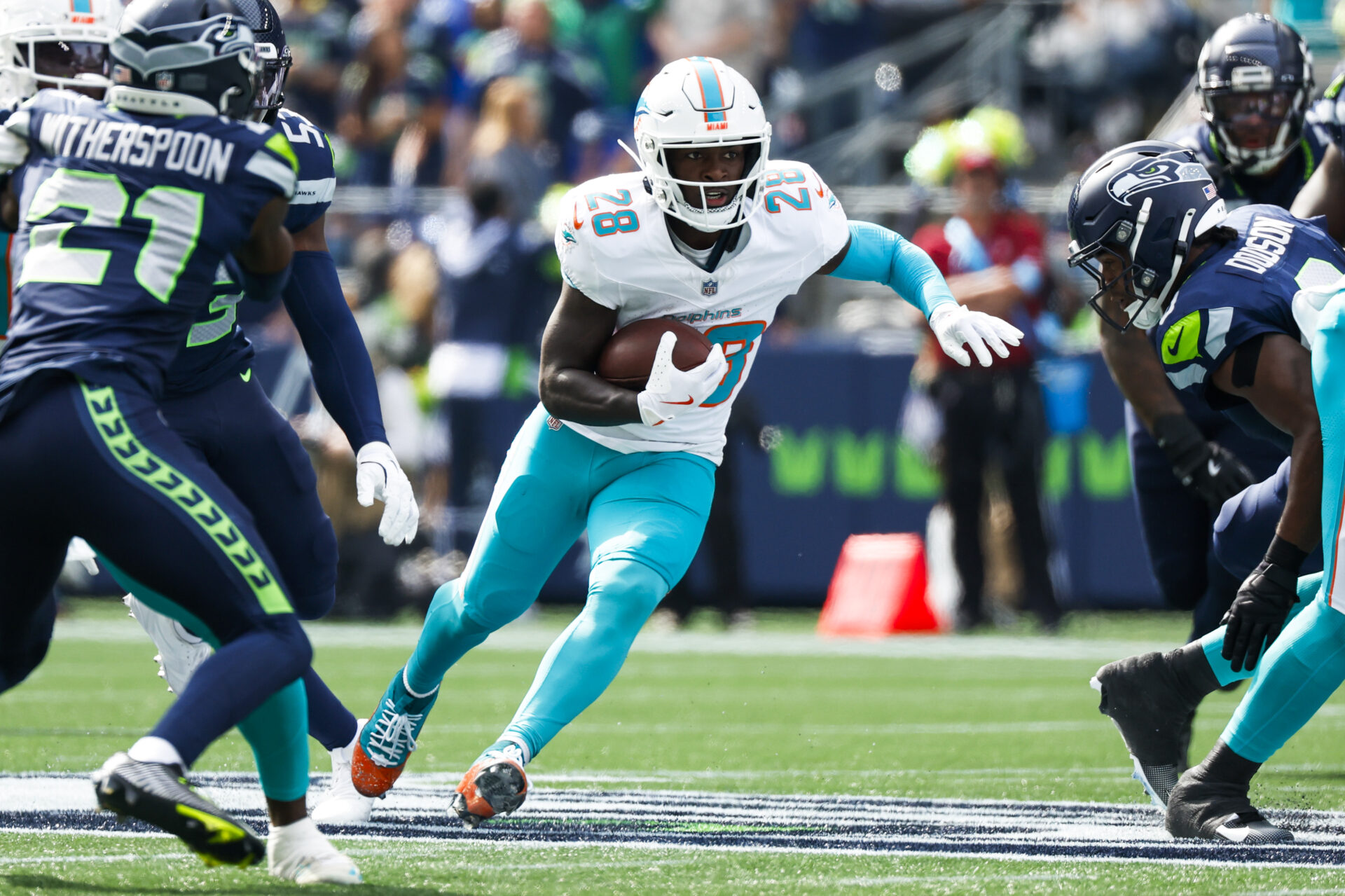 Sep 22, 2024; Seattle, Washington, USA; Miami Dolphins running back DeVon Achane (28) rushes against the Seattle Seahawks during the first quarter at Lumen Field.