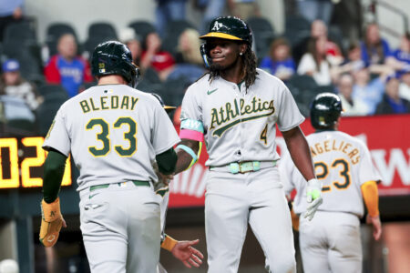 Apr 30, 2025; Arlington, Texas, USA; Oakland Athletics right fielder Lawrence Butler (4) celebrates with Oakland Athletics center fielder JJ Bleday (33) after hitting a grand slam during the ninth inning against the Texas Rangers at Globe Life Field.