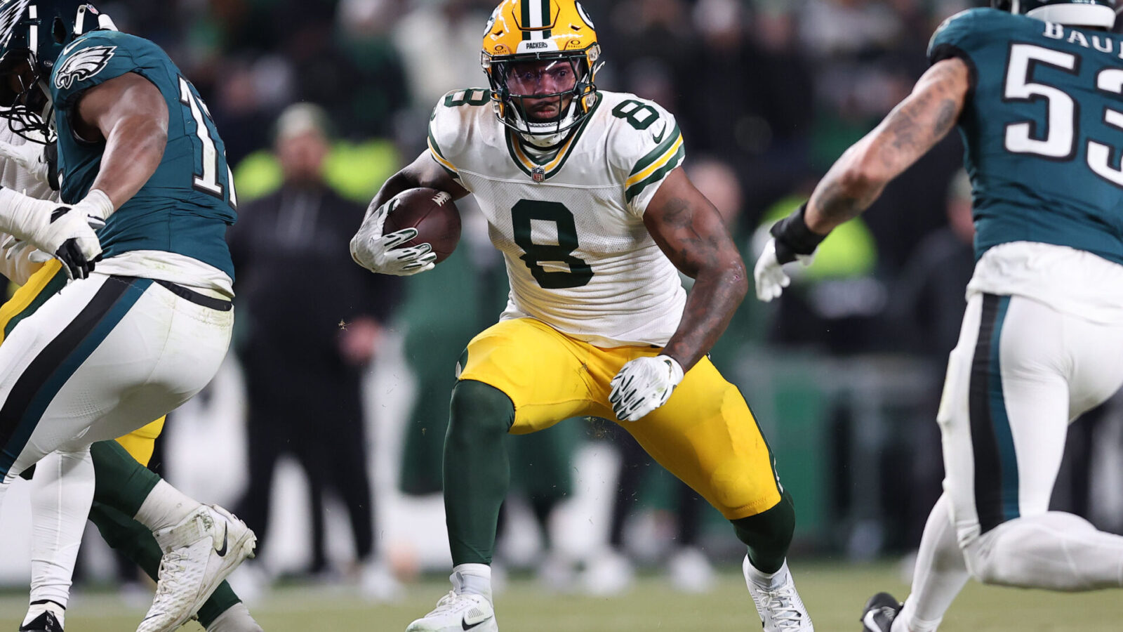 Jan 12, 2025; Philadelphia, Pennsylvania, USA; Green Bay Packers running back Josh Jacobs (8) rushes the ball against the Philadelphia Eagles during the first half in an NFC wild card game at Lincoln Financial Field.