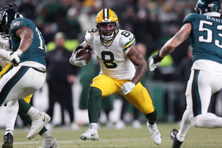 Jan 12, 2025; Philadelphia, Pennsylvania, USA; Green Bay Packers running back Josh Jacobs (8) rushes the ball against the Philadelphia Eagles during the first half in an NFC wild card game at Lincoln Financial Field.