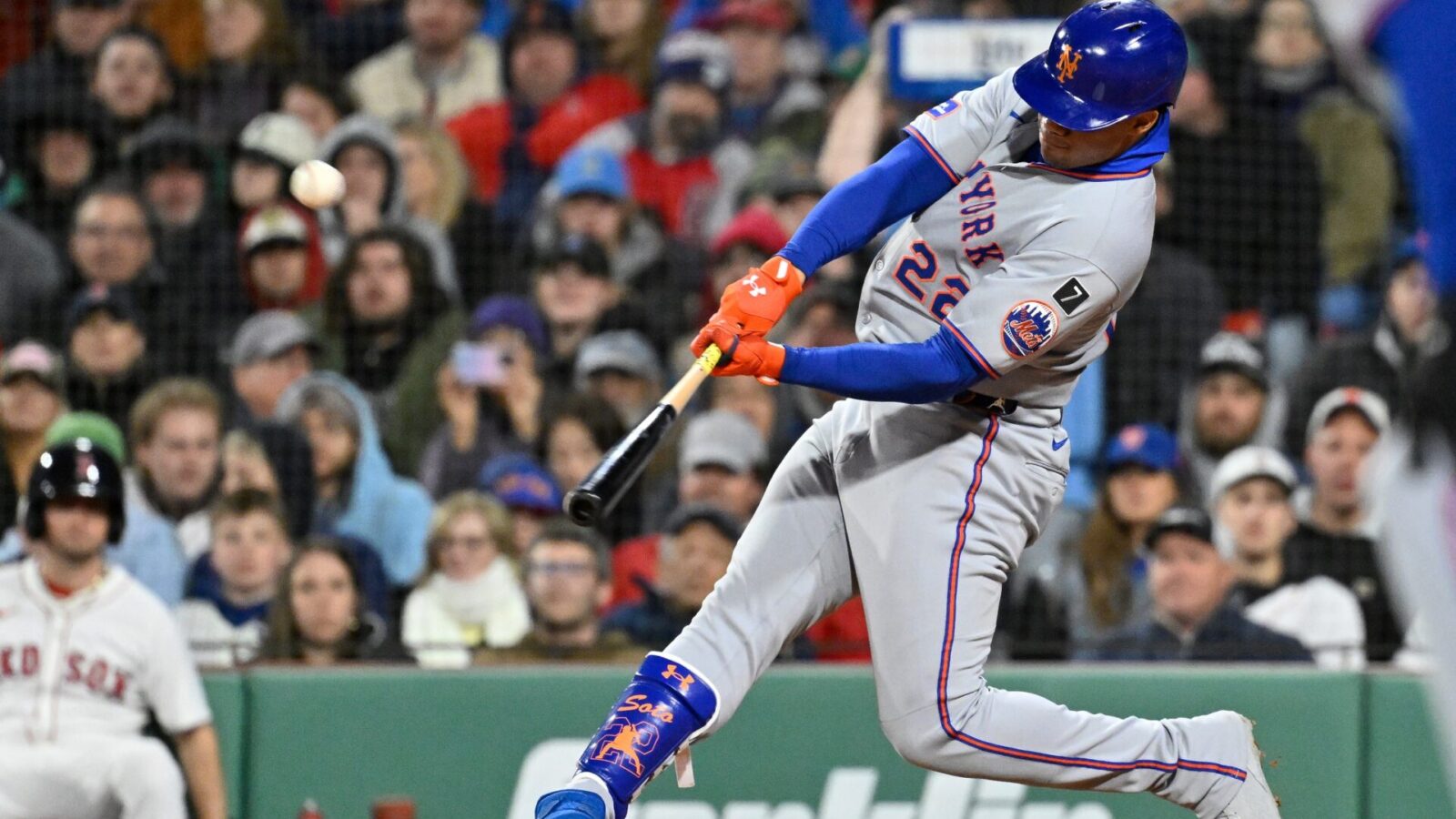 May 21, 2025; Boston, Massachusetts, USA; New York Mets right fielder Juan Soto (22) hits a RBI sacrifice fly during the seventh inning against the Boston Red Sox at Fenway Park.