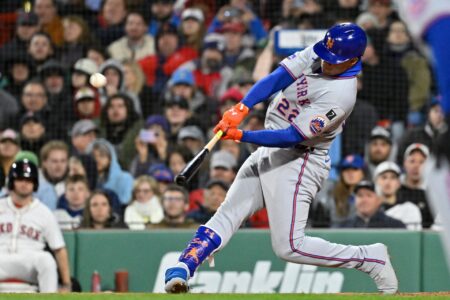 May 21, 2025; Boston, Massachusetts, USA; New York Mets right fielder Juan Soto (22) hits a RBI sacrifice fly during the seventh inning against the Boston Red Sox at Fenway Park.