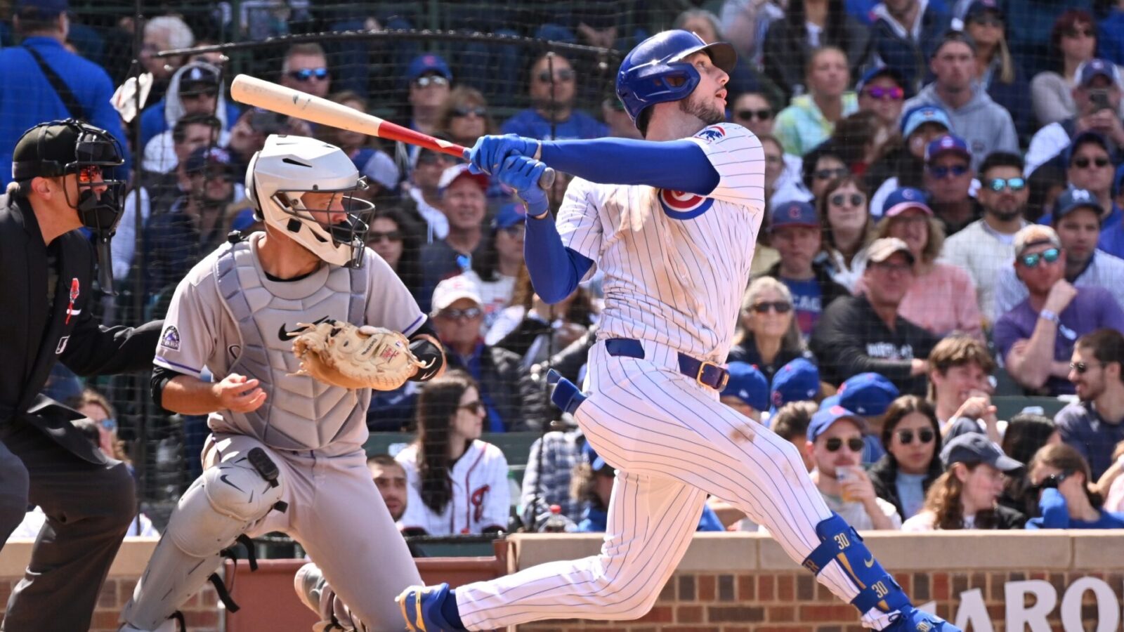 May 26, 2025; Chicago, Illinois, USA; Chicago Cubs right fielder Kyle Tucker (30) hits an RBI sacrifice fly ball during the seventh inning against the Colorado Rockies at Wrigley Field.