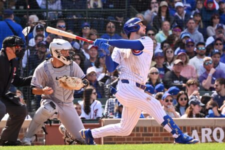May 26, 2025; Chicago, Illinois, USA; Chicago Cubs right fielder Kyle Tucker (30) hits an RBI sacrifice fly ball during the seventh inning against the Colorado Rockies at Wrigley Field.