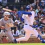 May 26, 2025; Chicago, Illinois, USA; Chicago Cubs right fielder Kyle Tucker (30) hits an RBI sacrifice fly ball during the seventh inning against the Colorado Rockies at Wrigley Field.