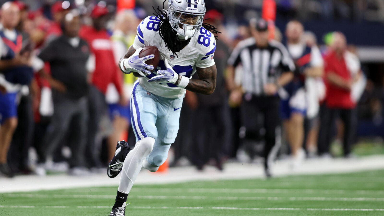 Dec 22, 2024; Arlington, Texas, USA; Dallas Cowboys wide receiver CeeDee Lamb (88) runs after catching a pass against the Tampa Bay Buccaneers in the second quarter at AT&T Stadium.