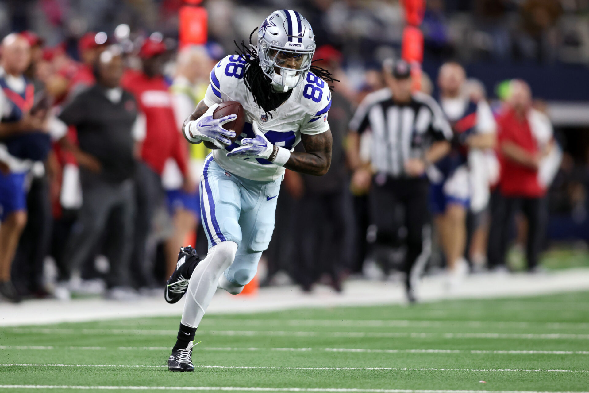 Dec 22, 2024; Arlington, Texas, USA; Dallas Cowboys wide receiver CeeDee Lamb (88) runs after catching a pass against the Tampa Bay Buccaneers in the second quarter at AT&T Stadium.