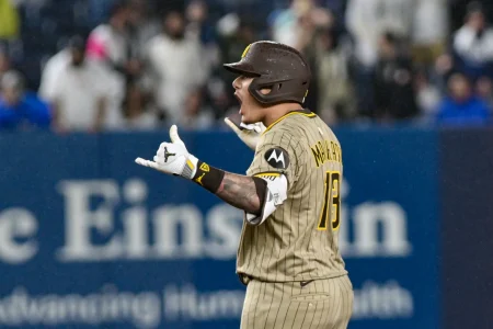 May 5, 2025; Bronx, New York, USA; San Diego Padres third baseman Manny Machado (13) reacts after hitting a two RBI double against the New York Yankees during the eighth inning at Yankee Stadium.