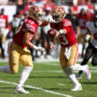 Nov 10, 2024; Tampa, Florida, USA; San Francisco 49ers quarterback Brock Purdy (13) hands off to running back Christian McCaffrey (23) against the Tampa Bay Buccaneers in the third quarter at Raymond James Stadium.