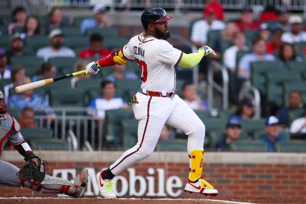 May 8, 2025; Atlanta, Georgia, USA; Atlanta Braves designated hitter Marcell Ozuna (20) hits a single against the Cincinnati Reds in the first inning at Truist Park.