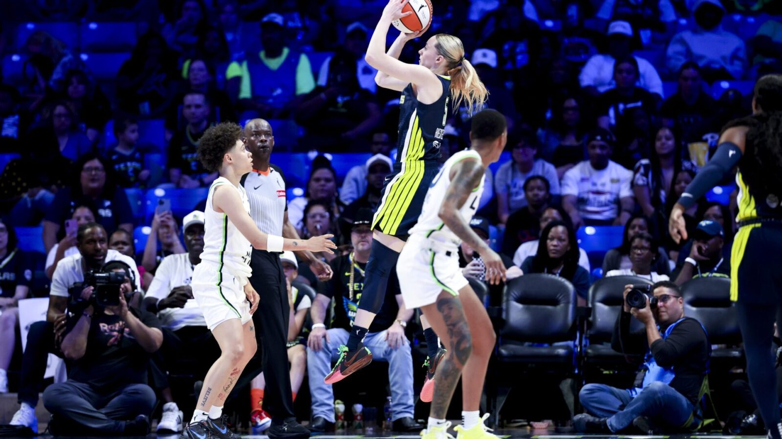 May 16, 2025; Arlington, Texas, USA; Dallas Wings guard Paige Bueckers (5) scores over Minnesota Lynx guard Natisha Hiedeman (2) during the first half at College Park Center.