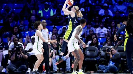 May 16, 2025; Arlington, Texas, USA; Dallas Wings guard Paige Bueckers (5) scores over Minnesota Lynx guard Natisha Hiedeman (2) during the first half at College Park Center.