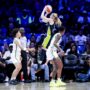May 16, 2025; Arlington, Texas, USA; Dallas Wings guard Paige Bueckers (5) scores over Minnesota Lynx guard Natisha Hiedeman (2) during the first half at College Park Center.