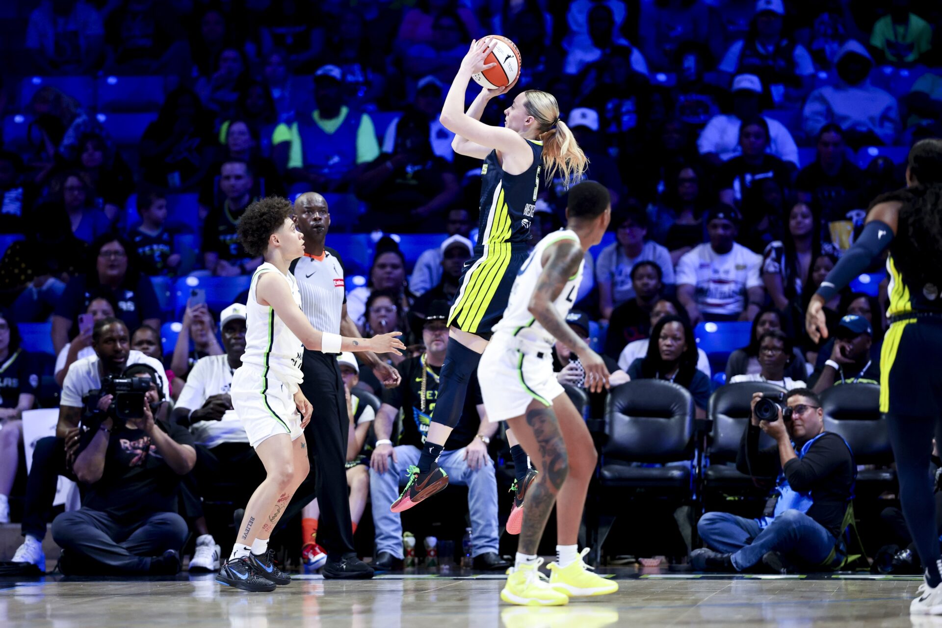 May 16, 2025; Arlington, Texas, USA; Dallas Wings guard Paige Bueckers (5) scores over Minnesota Lynx guard Natisha Hiedeman (2) during the first half at College Park Center.