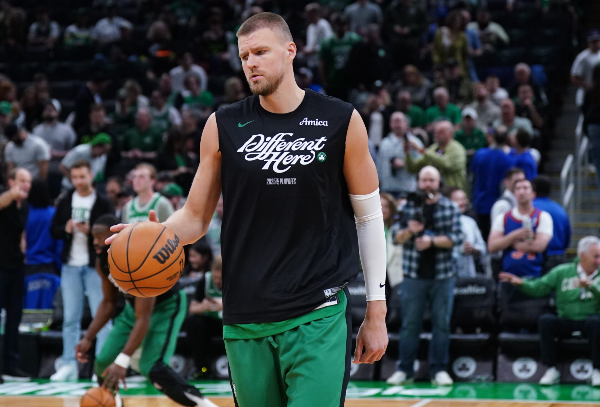 May 7, 2025; Boston, Massachusetts, USA; Boston Celtics center Kristaps Porzingis (8) warms up before the start of game two of the second round for the 2025 NBA Playoffs against the New York Knicks at TD Garden.