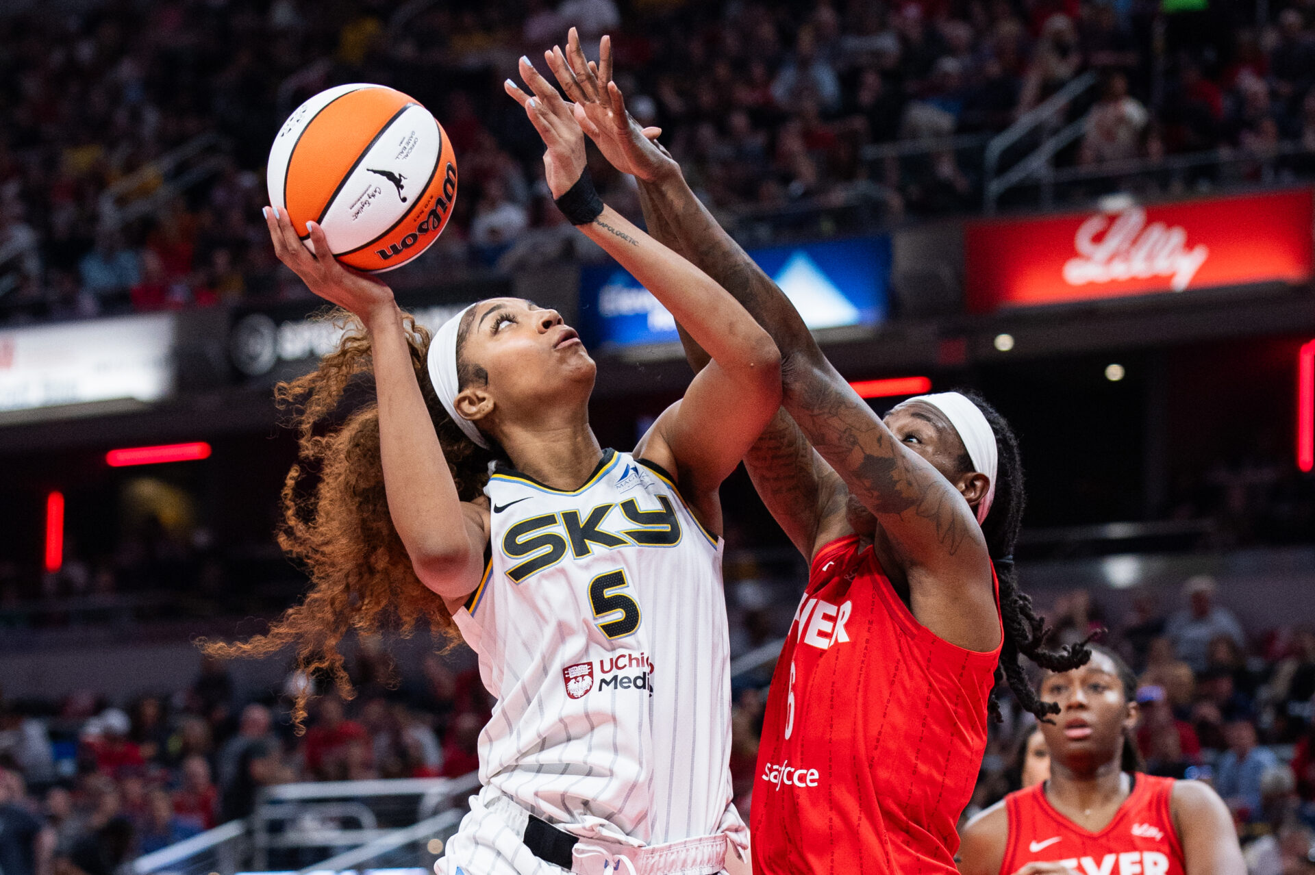 May 17, 2025; Indianapolis, Indiana, USA; Chicago Sky forward Angel Reese (5) shoots the ball while Indiana Fever forward Natasha Howard (6) defends in the second half at Gainbridge Fieldhouse.