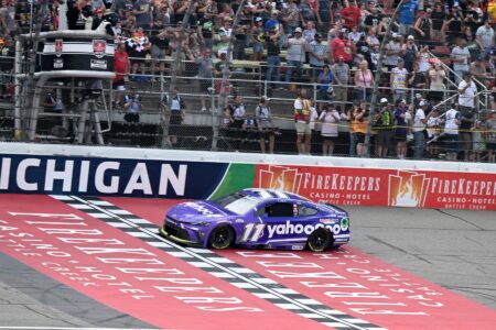 Jun 8, 2025; Brooklyn, Michigan, USA; NASCAR Cup Series driver Denny Hamlin (11) crosses the finish line to win the FireKeepers Casino 400 at Michigan International Speedway.